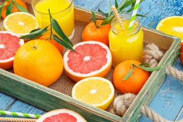 Fototapeten Different fruits and glass with fresh orange juice, wooden background © lisssbetha