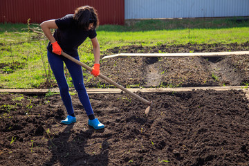 Girl with a hoe in the garden