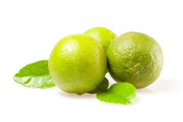 Lime fruits and piece with leaves isolated on white background.