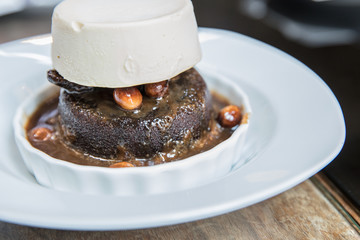 Dates and walnut cake with caramel sauce with topping of vanilla ice cream
