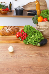 Desk  with many fresh vegetables and fruits in the kitchen. Cooking, vegetarian and shopping concept.