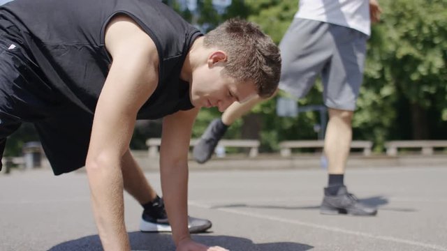 Basketball players stretching on an outdoor playground