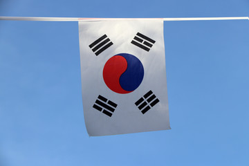 Mini fabric rail flag of South Korea, a white rectangular background, a red and blue Taeguk, symbolizing balance and four black trigrams