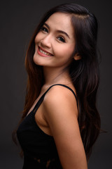 Fototapeta na wymiar Young beautiful Asian woman smiling
