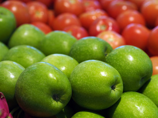 bulk fresh green apple fruits in basket for sale in supermarket