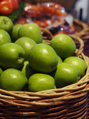 bulk fresh green apple fruits in basket for sale in supermarket