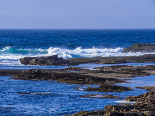 Fototapeta na wymiar Wild Atlantic ocean water at a rocky coast