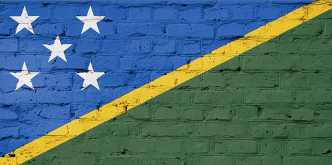 Texture of  Solomon islands  flag  on a pink brick wall.