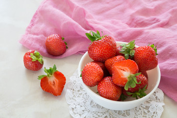ripe red strawberries in a white bowl