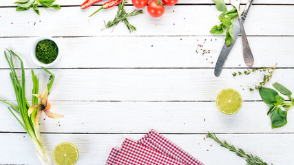 The background of cooking. Fresh vegetables and spices. On a wooden background. Top view. Copy space.