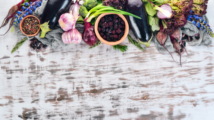 Purple food. Fresh vegetables and berries. On a white wooden background. Top view. Copy space.