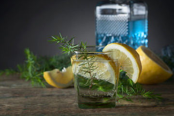 Blue gin , tonic and lemon on a old wooden table.