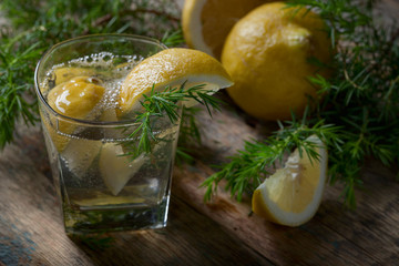 Blue gin , tonic and lemon slices on a old wooden table.