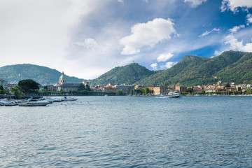 Como lake, Como city, northern Italy. View of Como city on a beautiful summer morning with a departing hydrofoil