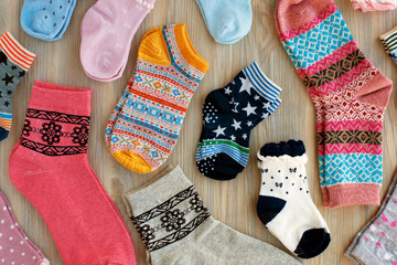 Socks of different sizes. Socks of different colors and patterns for adults and children. View from above.