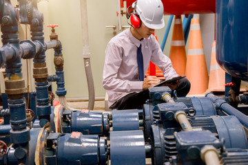 Engineer checking Condenser Water pump and pressure gauge , chiller water pump with pressure gauge....