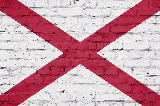 Texture of Alabama flag on a pink brick wall.