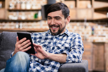 Smiling young man using his tablet