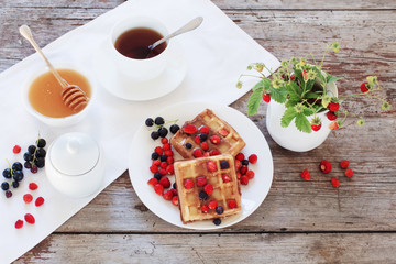 breakfast with berries on old wooden table