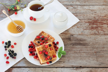 breakfast with berries on old wooden table