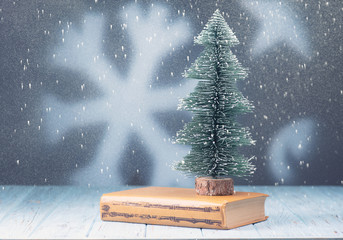 Christmas tree and book on the table.