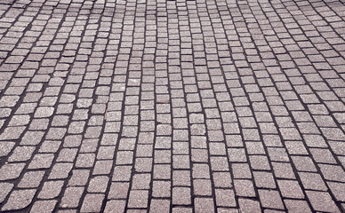 View of an old cobblestone street, color toned urban background.