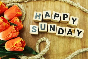 happy sunday on wooden background