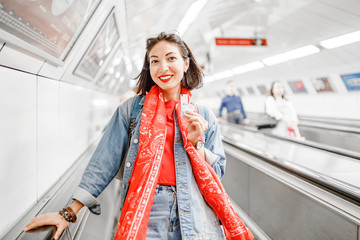 Young woman standing at the escalator in subway