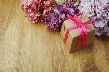 top view pink gift box present with ribbon on wooden background
