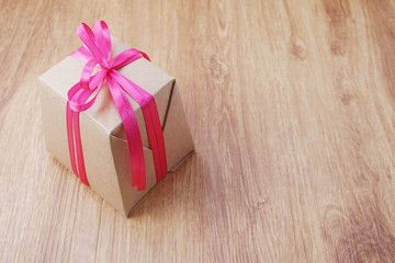 top view gift box present with ribbon on wooden background