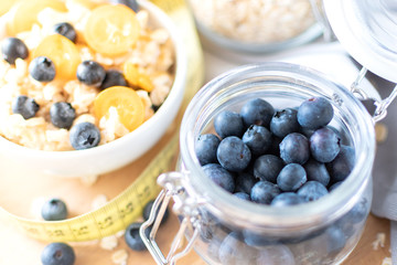 fresh blueberries in a clear glass jar, Breakfast ingredients blueberries and oatmeal. healthy Breakfast concept, selective focus
