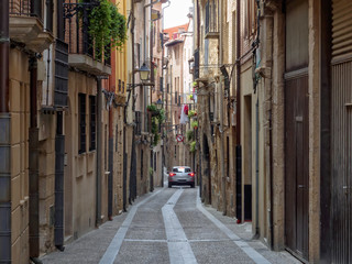 Car in a narrow cobblestone alley - Viana, Navarre, Spain