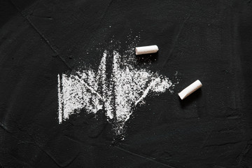 A few pieces of white chalk lie on the board for writing your own work. DIY. Hand made. Copy space..