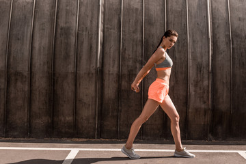 Fototapeta premium beautiful athletic woman exercising on parking