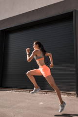 young attractive sportswoman running in sportswear