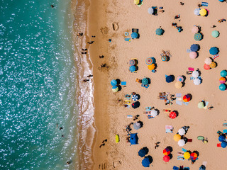 Aerial View From Flying Drone Of People Crowd Relaxing On Algarve Beach In Portugal