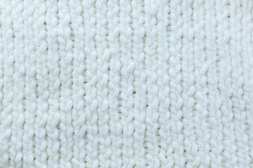 White knitted needles texture, pigtails, vertical.