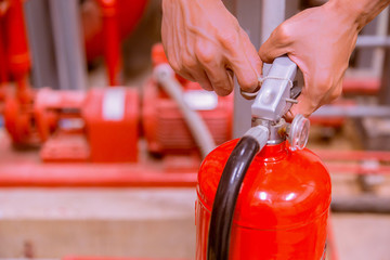 Close up Fire extinguisher and pulling pin on red tank.