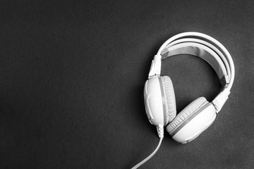 White headphones on black backgrounds.