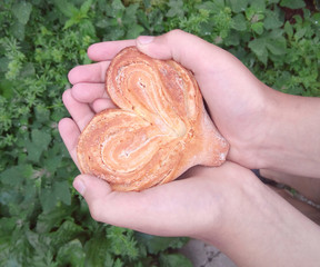 Bun in the shape of heart in the palms