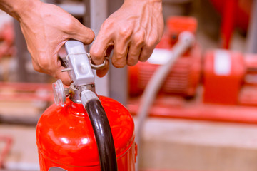 Close up Fire extinguisher and pulling pin on red tank.