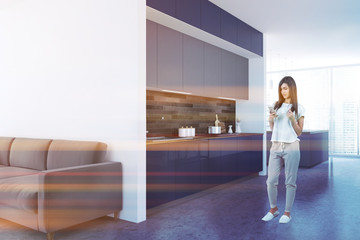 White kitchen corner, blue countertops, woman