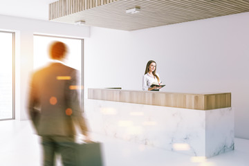 Marble reception in white office lobby, people