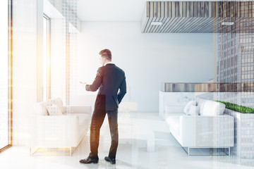 White and wooden office waiting room, man