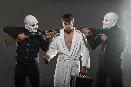 Masked robbers Rob a man with a case