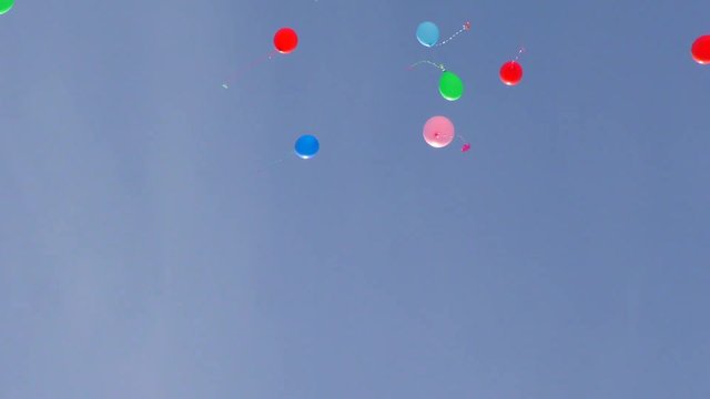 Helium balloons fly into the sky. Festive launch of balloons. 