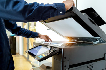 Bussiness man Hand press button on panel of printer, printer scanner laser office copy machine...
