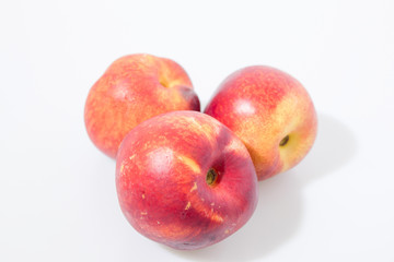 Red peach fruits isolated in a white background