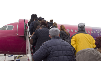 people going on jurney on airplane stairs.