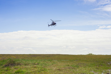 Fototapeta na wymiar helicopter on mountain landscape